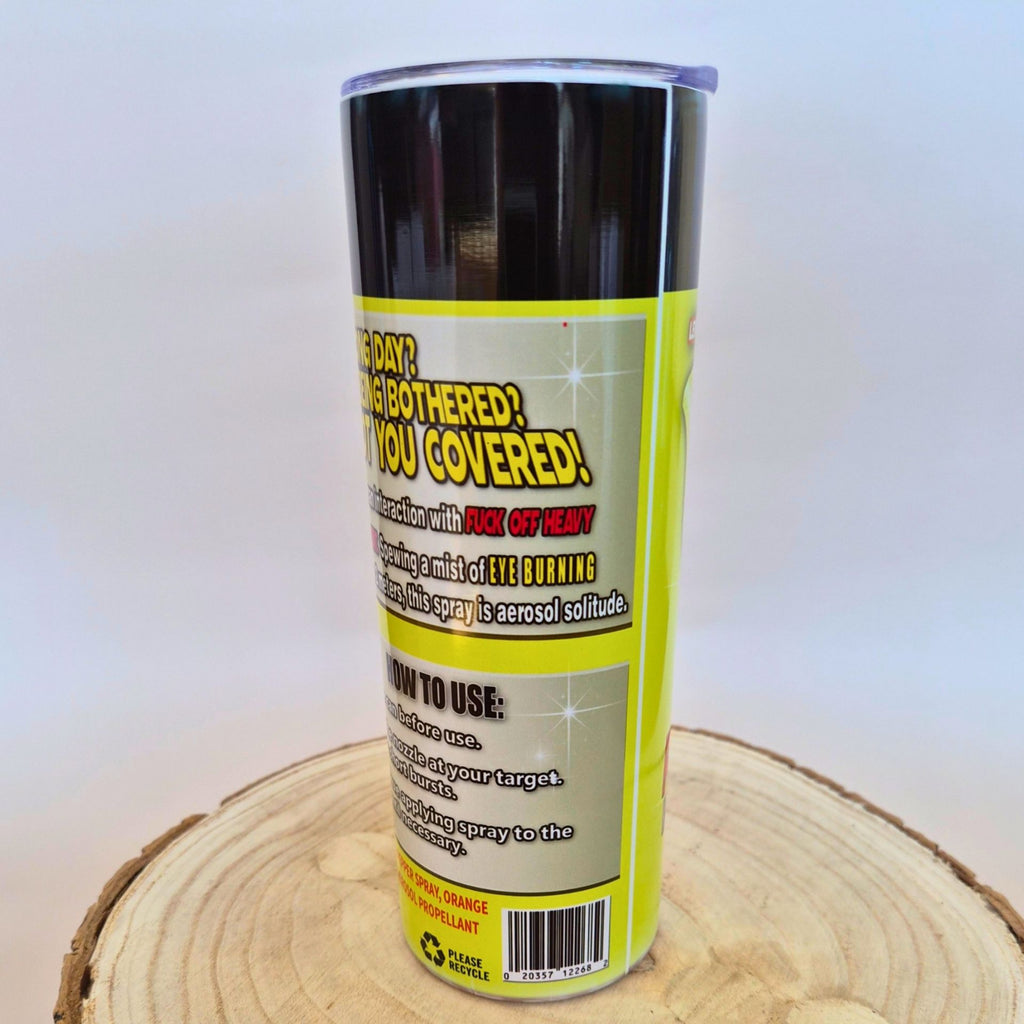 A cylindrical canister of 'This Day I Was Bothered? You Covered!' adhesive earplugs, shown from the back label side, resting on a circular wood slice against a light gray background.